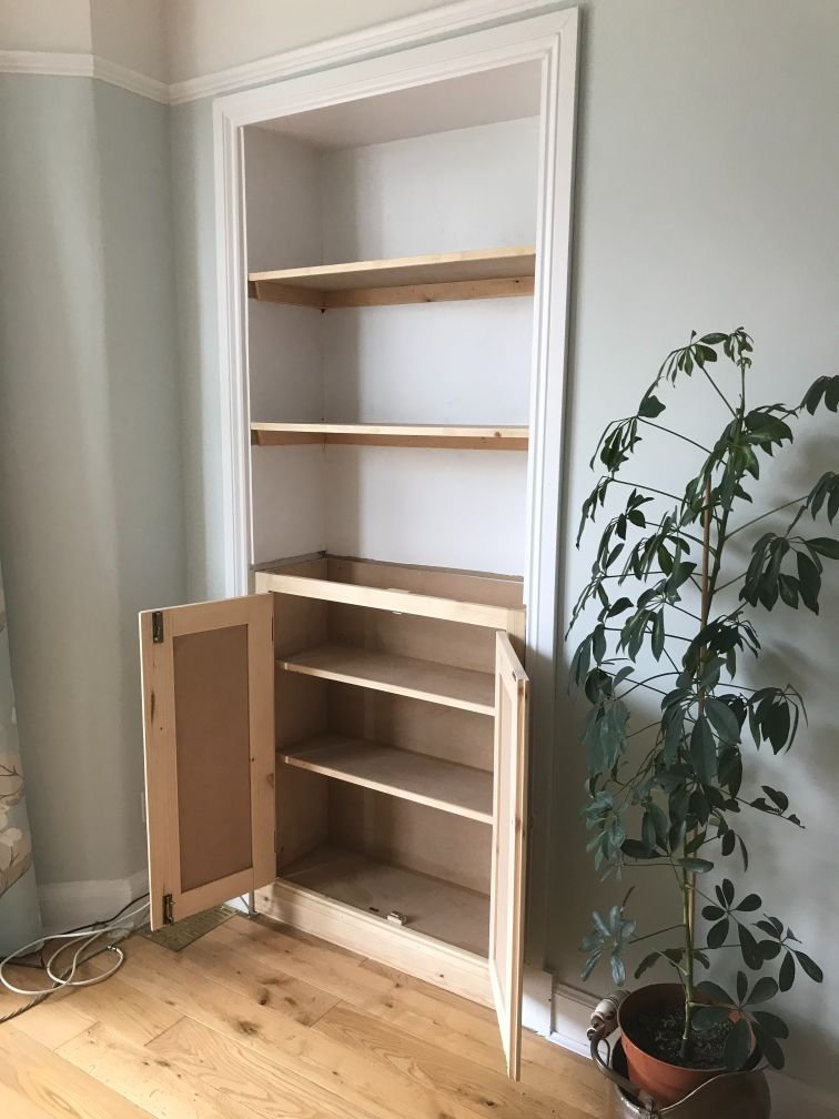 custom built shelving and cupboard using dead space