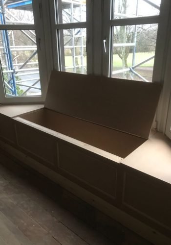 custom built under window seating cupboard